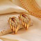 Decadent – Waterproof gouden oorbellen op gestylde achtergrond – Meena Rotterdam